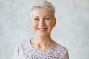 Smiling senior woman with digital dentures in Edison