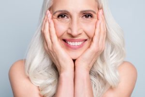 Smiling woman enjoying jawbone preservation with dental implants