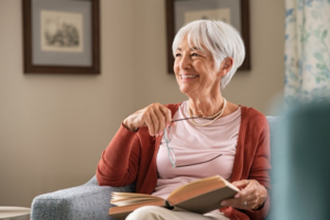 Woman smiling as she relaxes in her favorite armchair