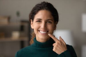 Woman smiling after getting professional teeth whitening